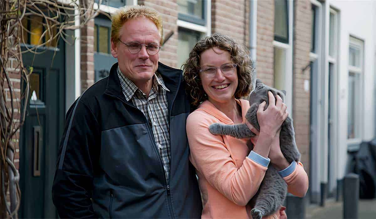 Dierenartsen Jan-Pieter en Manon Burger poseren met kat op de arm voor hun huis in Nederland voordat ze naar Duitsland vertrekken in het SBS6 programma Het Roer Om.